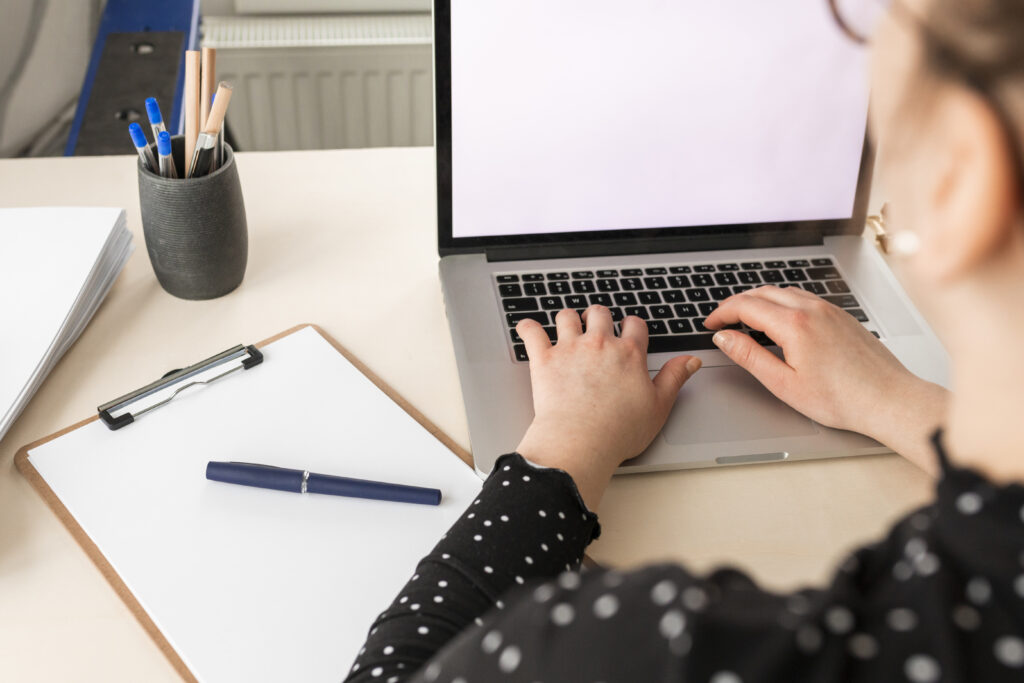 Home high angle woman working empty display laptop